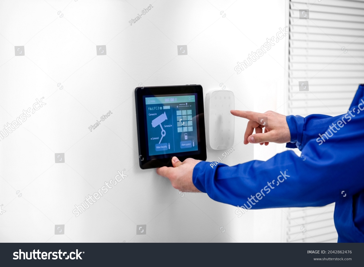 A worker with tablet computer checking alarms.